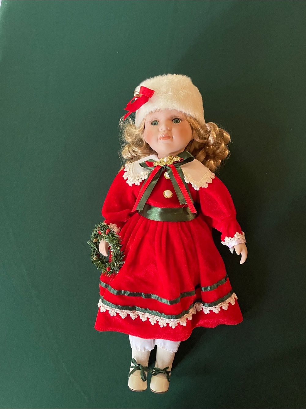 Festive Red Porcelain Holiday Doll with Wreath Accent
